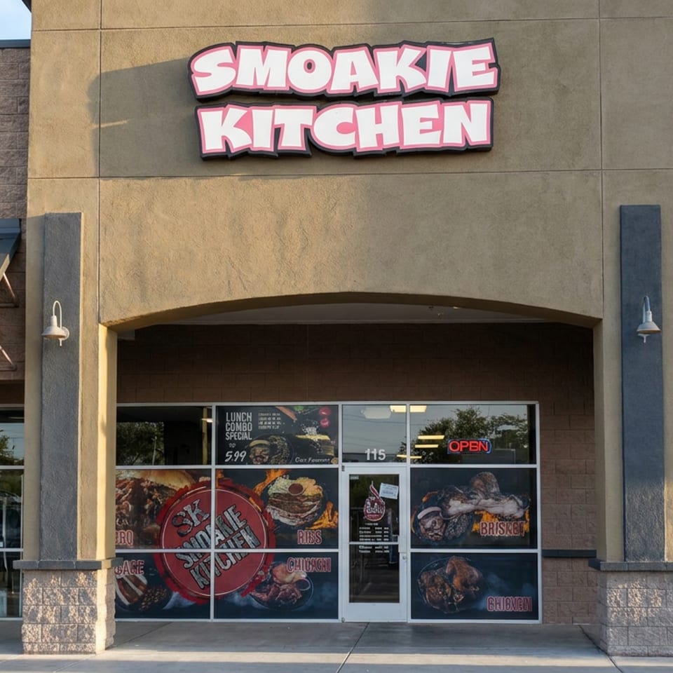 Smoke Kitchen restaurant storefront with barbecue food graphics, open sign, and lunch combo advertisement on the windows.